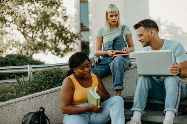 istock Discussing a group project with college friends 1687037306