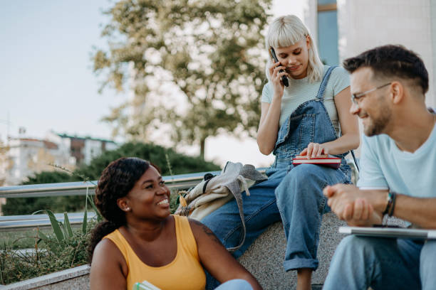 istock Cheerful group of young college students spending time together 1687037316