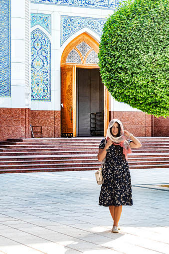 Lady walking in the internal courtyard of the minor mosque in Tashkent. Uzbekistan.