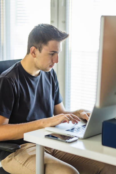 istock 20 years old man working from home 1687046637