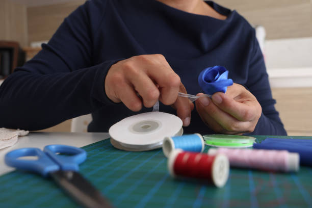 istock Woman designer is cutting fabric to make products 1687054326