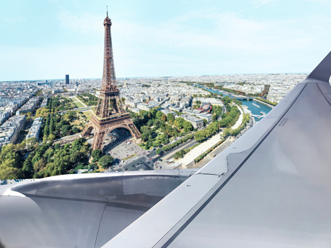 Looking out to Eiffel Tower in Paris from a flying passenger plane window
