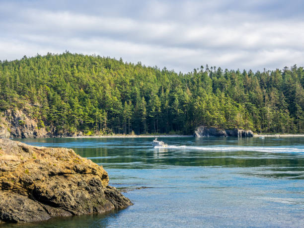 Power boat is moving towards bridge at Deception Pass