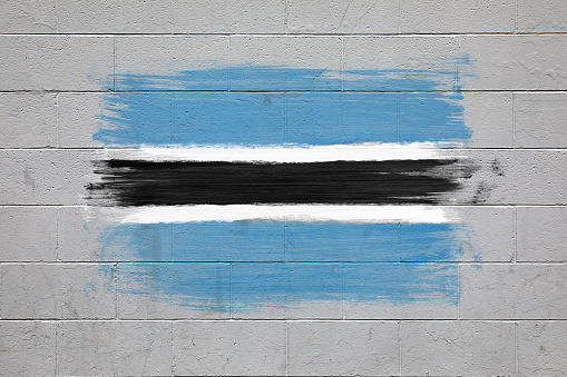 Close up of Botswana flag color of blue, black and white painted on brick wall