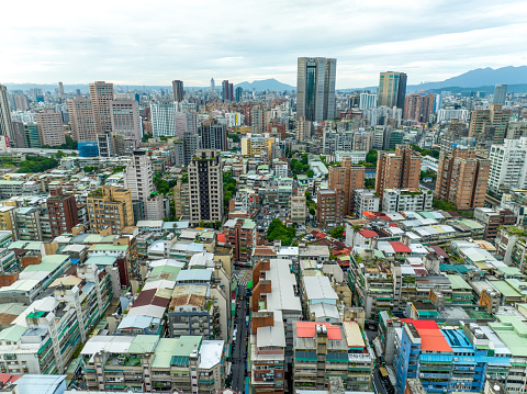 Aerial view of the cityscape of Taipei, Taiwan, where many buildings are densely packed