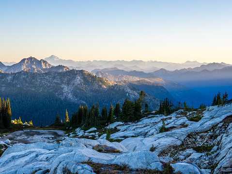 First morning light on mountain range seen from Robin lake in Central Cascades