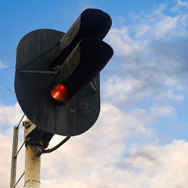istock Railway semaphore shows red signal over cloudy sky 168710756