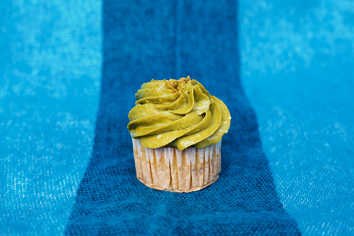 Pistachio cupcake on a blue background