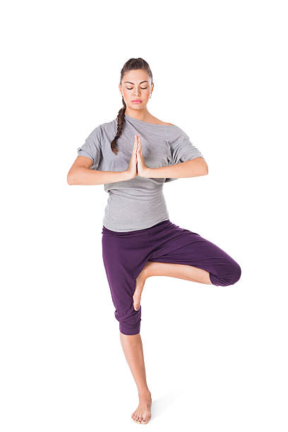 istock Young woman doing yoga exercise tree-pose isolated on white 168710954