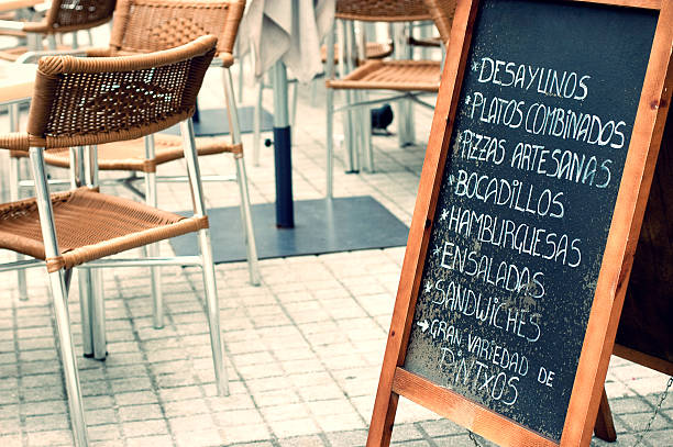 Tabloid offering fast food in an empty terrace in San Sebastian, Spain. Vintage effect edition.