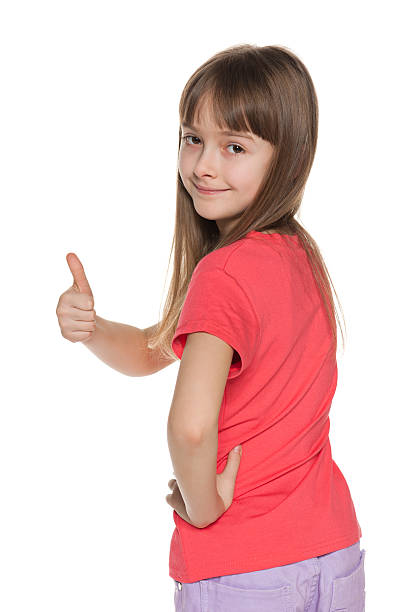 istock Young girl looks back and holds her thumb up 168712773