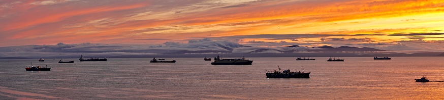 Multicolored sunset stripes. Sunset in the Sea of Japan. Sea sunsets in the city of Vladivostok. Beautiful sea sunset. Ships at sea during sunset.