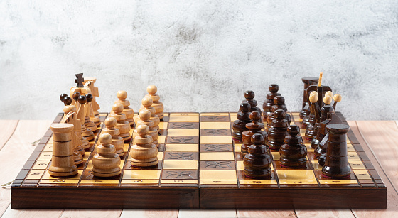 Side view of a traditional hand-carved wooden chess set.