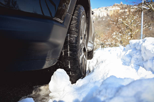 istock Car tires on winter road. 1687147014