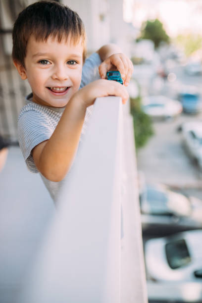 Little boy looking outside from the balcony
