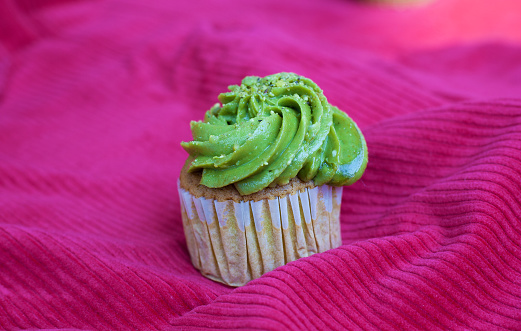 Pistachio cupcake on a red tablecloth