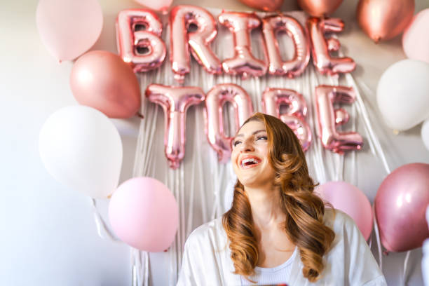 istock Young bride's make-up and hair being done on her wedding day 1687152940