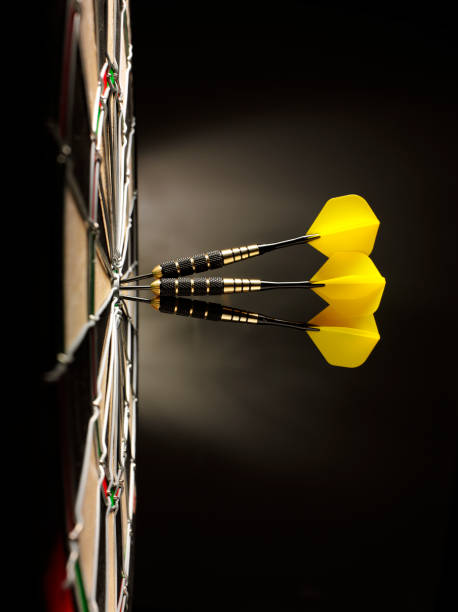 tres amarillo de dardos en un juego de dardos - dartboard dart bulls eye scoring fotografías e imágenes de stock