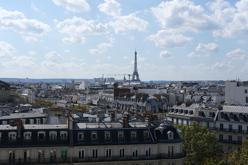 A wide view of the roofs of Paris and the Eiffel Tower. Paris, France - September 15th, 2023.