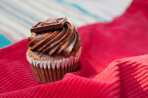 Chocolate cupcake on a red tablecloth