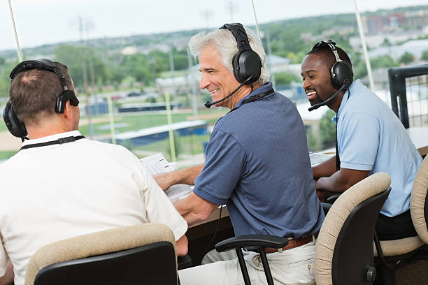 istock Sportscasters discussing sports game in a press box 168719499