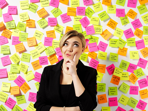 Business women with surrounded by post it notes.