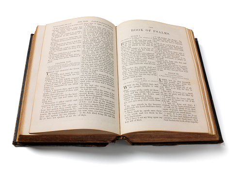 Antique holy bible showing the book of psalms. Isolated on white with clipping path.