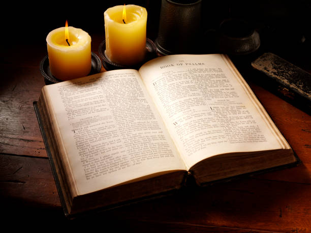 Antique holy bible showing the book of psalms on a old table.