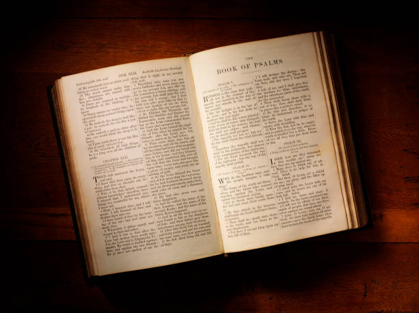Antique holy bible on a old table showing the book of psalms.
