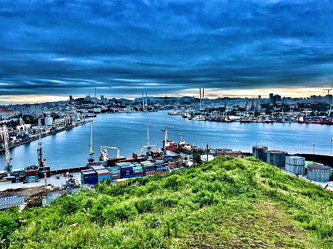 Panoramic view of Vladivostok. Vladivostok in the evening. Vladivostok is a city by the sea. Top view of the Golden Horn Bay and the bridge. Commercial port and the whole city of Vladivostok.