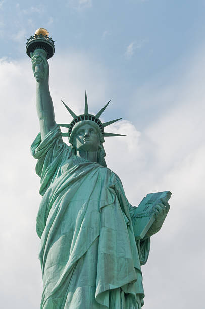istock Statue of Liberty with Blue Sky and White Clouds 168722257