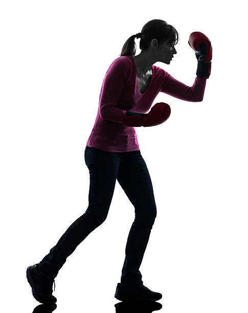 istock mature woman with boxing gloves silhouette 168723737