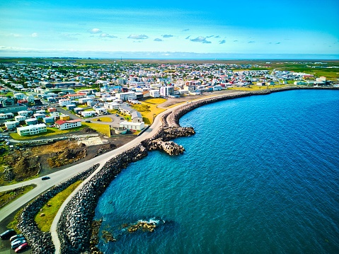 Aerial view of a coastal city, featuring a beach area and its surrounding urban environment