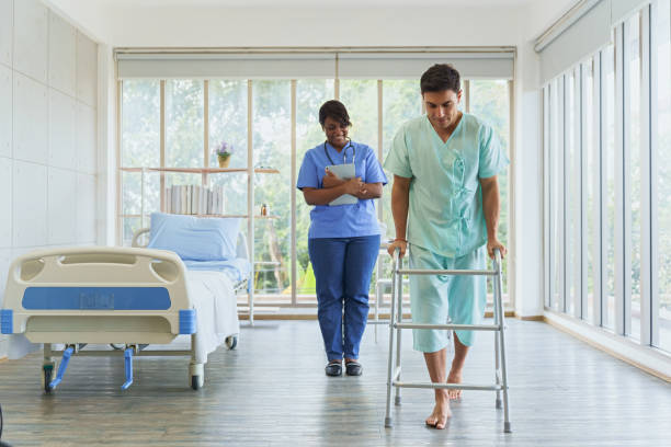istock Docter helping patients learn to walking training. Chiropractor do treatment, orthopedic for rehabilitation, therapy, rehab for patient return to normal. physiotherapist and patient in hospital. 1687243882