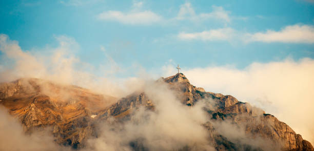 istock Cross at the top of a mountain 168724531