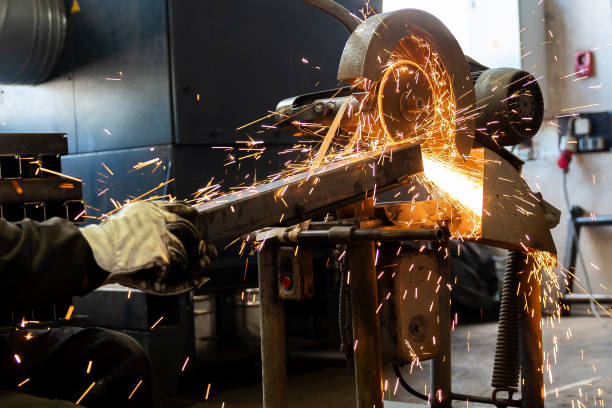 istock The man is cutting a metal box using cutting machine and the fire sparks splashes outside. 1687247648