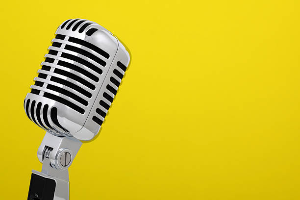 istock Vintage microphone isolated on yellow 168724838