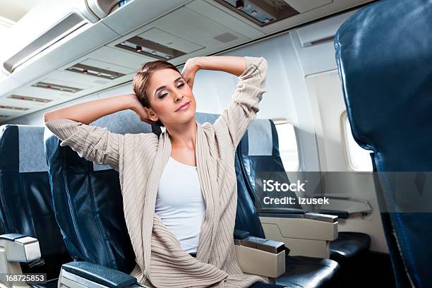 Woman On An Airplane Stock Photo - Download Image Now - Stretching, Airplane, Airport