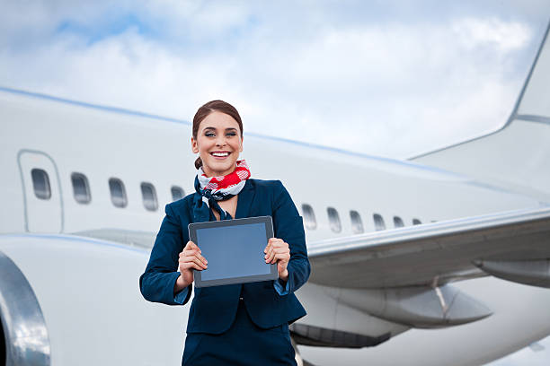 istock Beautiful air stewardess with a digital tablet 168725863