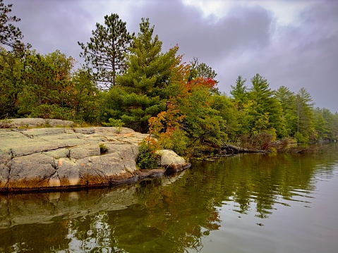 Sand Point on the Edge of a Lake with a Kayak pulled on shore on a sunny summer day in South western Ontario (Lake Erie at Hillman marsh)