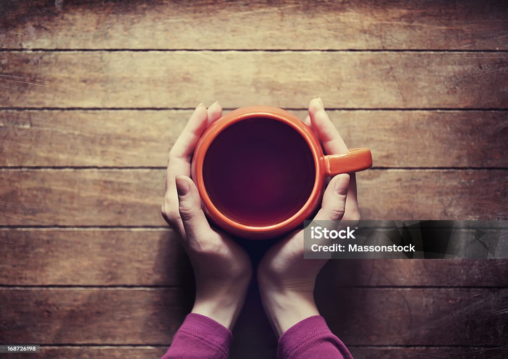 woman holding hot cup of tea Addiction Stock Photo