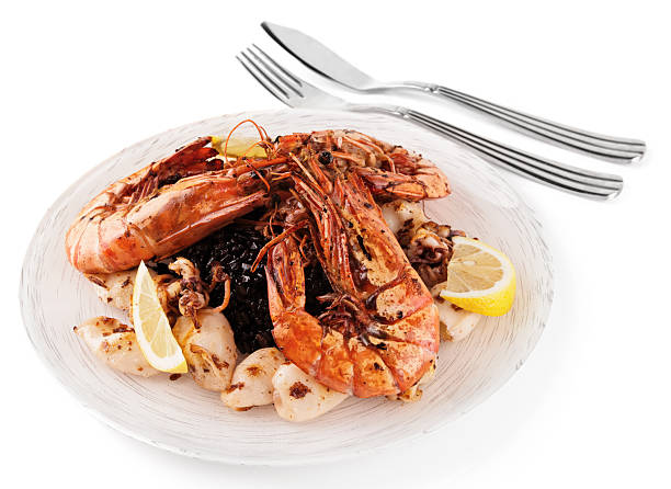 istock Jumbo prawns and grilled squids with black rice 168726294