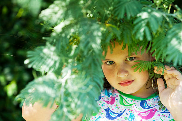 istock very nice child behind a plant 168727176