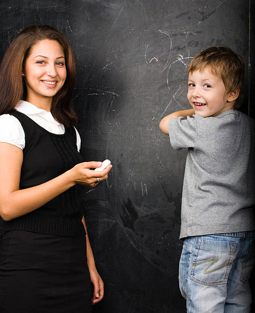 istock little cute boy in classroom with teacher 168728628