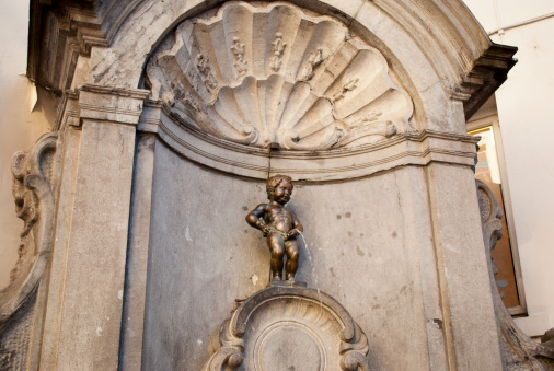Manneken Pis also known in French as le Petit Julien), is a famous Brussels landmark. It is a small bronze fountain sculpture depicting a naked little boy urinating into the fountain's basin