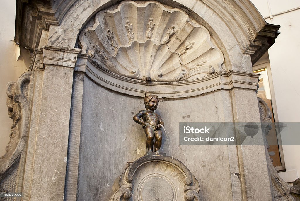Manneken piss in Brussel (Belgium) Manneken Pis also known in French as le Petit Julien), is a famous Brussels landmark. It is a small bronze fountain sculpture depicting a naked little boy urinating into the fountain's basin Mannekin Pis Stock Photo