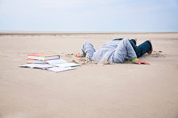 istock Overstrained child stucks head in sand 168729460