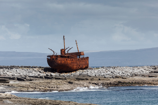 The cargo vessel Plassey  shipwrecked off Inis OÃ­rr Ireland in the 1960s only its rusted hulk remains on the rocks at low tide