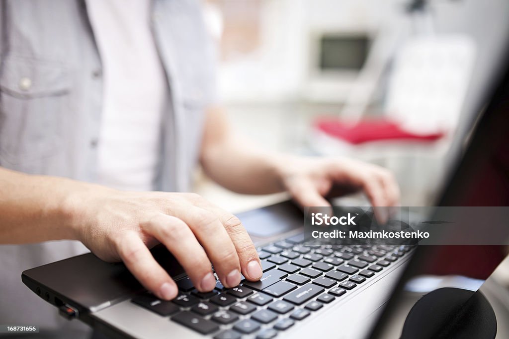 Man working on the laptop at home Adult Stock Photo