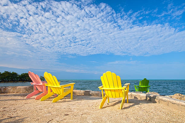 istock Summer scene with colorful lounge chairs on a tropical beach 168731881